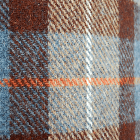 A brown, blue and orange checked Harris tweed fabric.