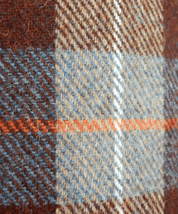 A brown, blue and orange checked Harris tweed fabric.