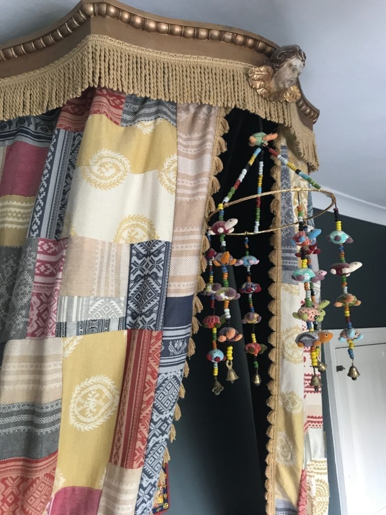 Decorative details on a half-tester bed at the home of textile designer, Julia Brendel.