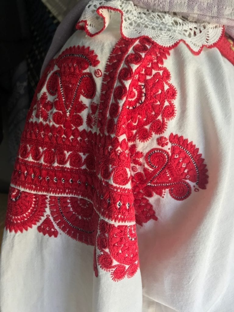 Embroidery details in bold red on white on a vintage Hungarian blouse.