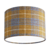 Cut out shot of a Harris tweed, grey and mustard drum shade available through Telescope Style.