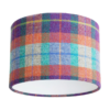 A cut out image of a Harris tweed check drum shade in zingy purple, orange, pale blue and turquoise from Telescope Style.