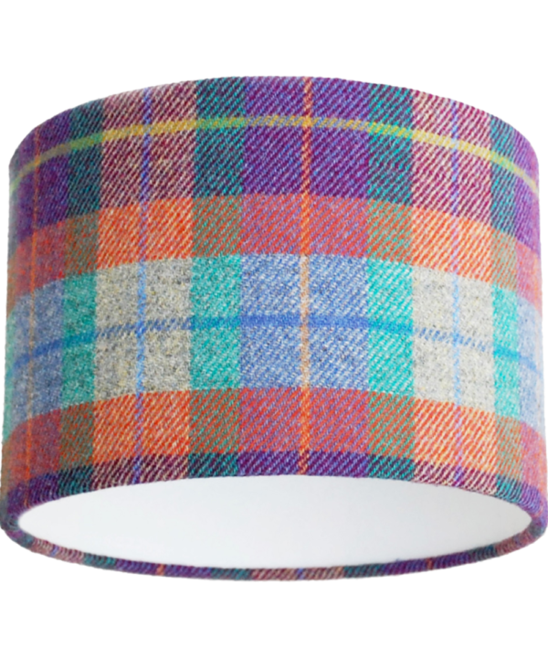 A cut out image of a Harris tweed check drum shade in zingy purple, orange, pale blue and turquoise from Telescope Style.