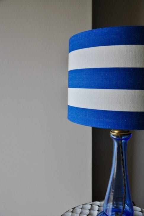 A shot of a stripy, drum lampshade in Royal blue and white.