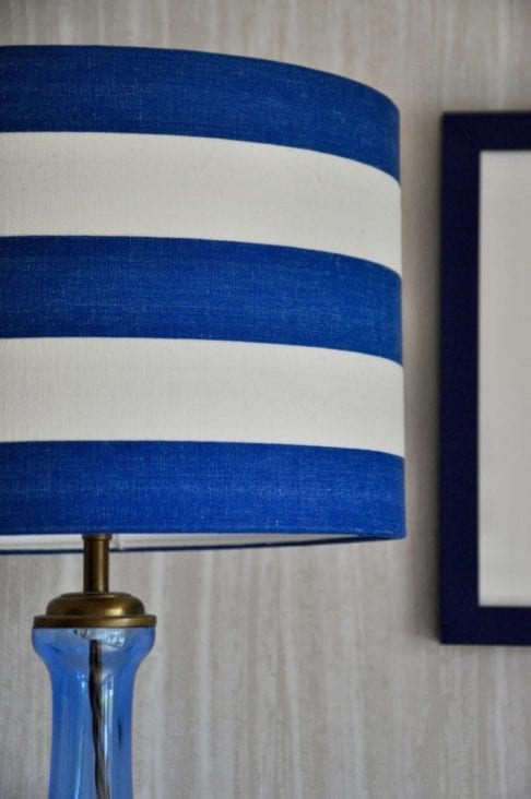 A Royal blue and white, striped, drum lampshade.