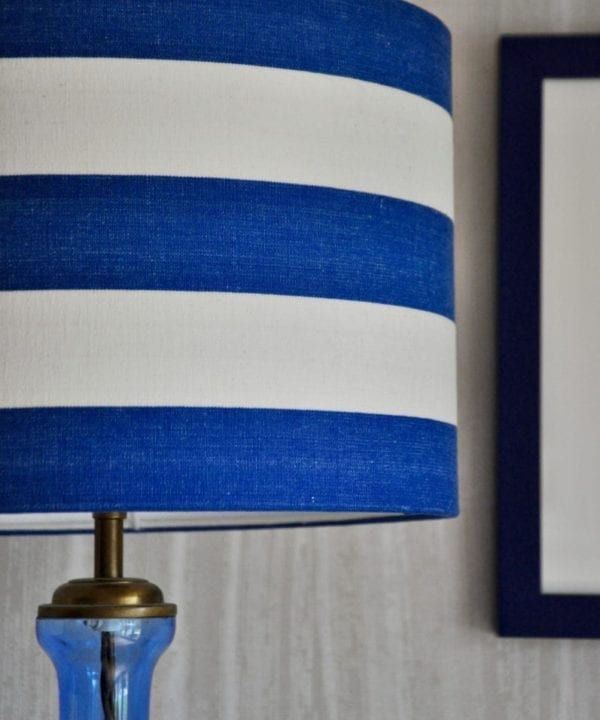 A Royal blue and white, striped, drum lampshade.