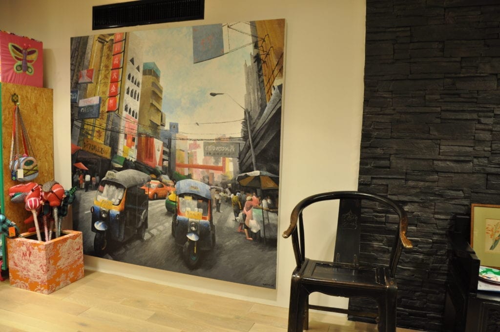 A colourful canvas painting depicting the streets of Bangkok in a Thai design store.