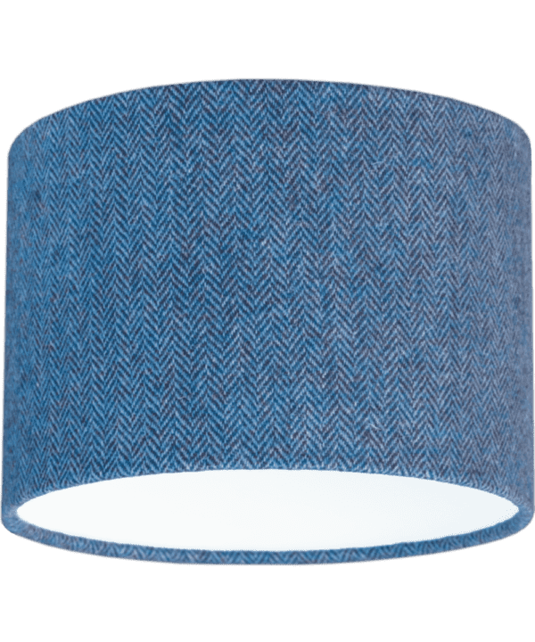 Cut out shot of a blue tweed drum shade with herringbone weave.