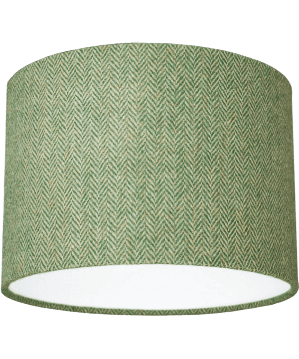 Cut out shot of a green tweed drum shade with herringbone weave.