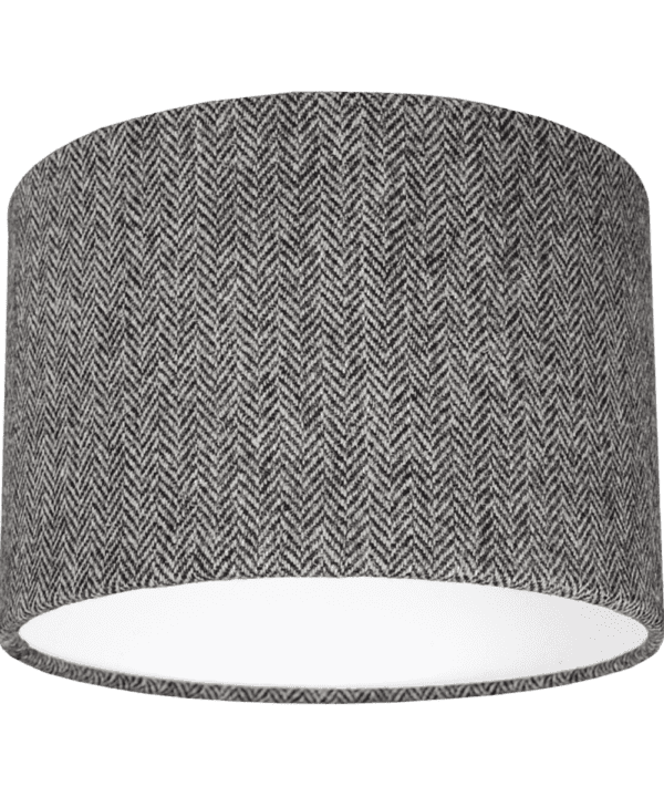 Cut out shot of a grey tweed drum shade with herringbone weave.