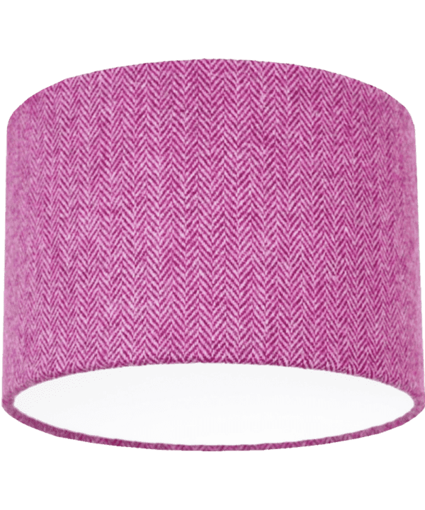 Cut out shot of a pink tweed drum shade with herringbone weave.