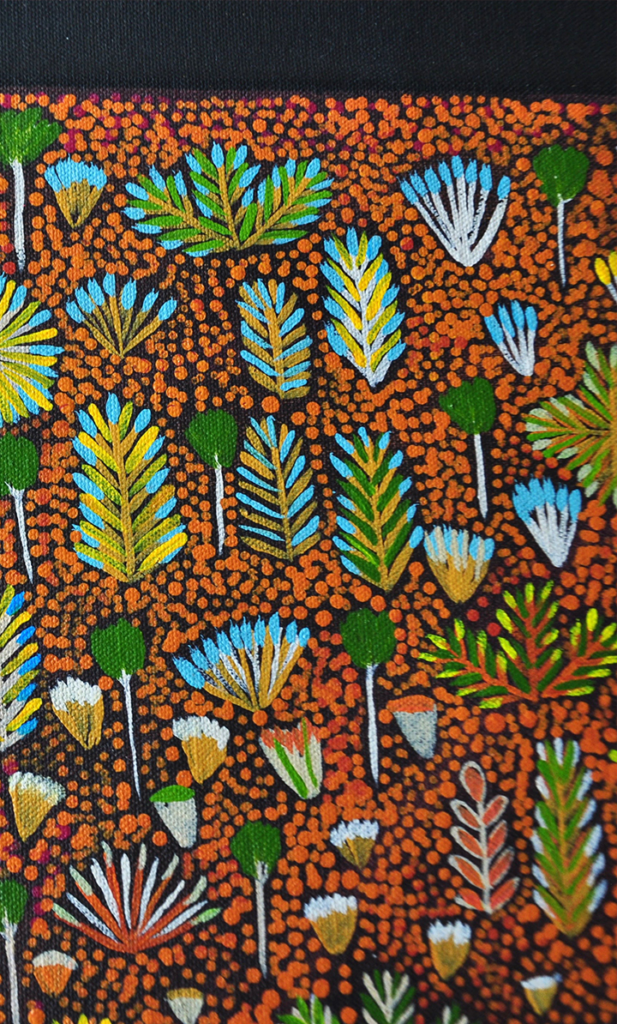 A detail of the 'Daisy' Aboriginal art wallpaper in brown.