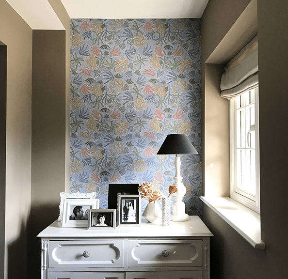 Styled shot of a hallway with feature wall in 'Michelle' Aboriginal symbols wallpaper in blue.