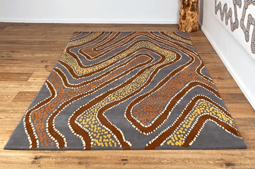 A striking, Aboriginal art rug in a neutral palette of browns and greys.