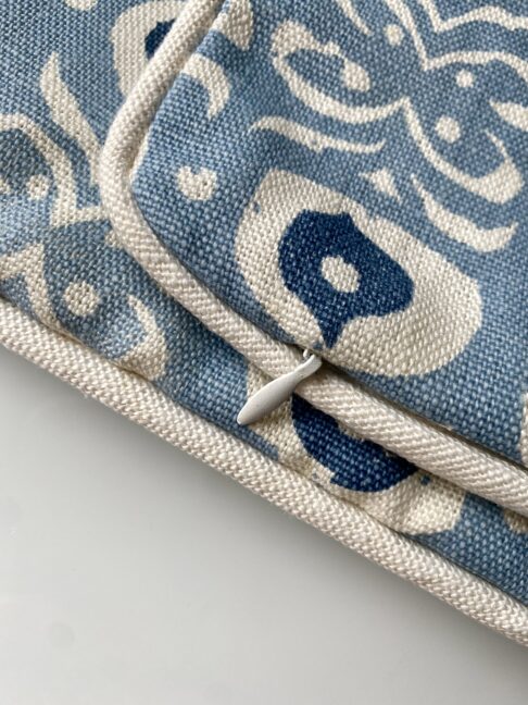 Discreet zip and piping detail on a bespoke, hand-print linen cushion cover.