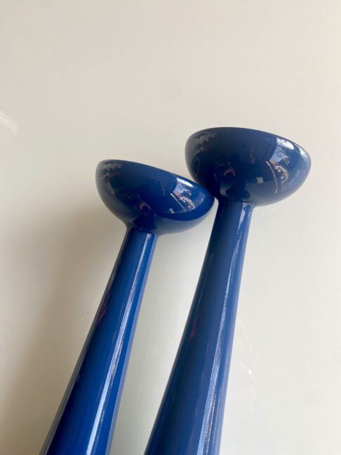 Blue candlesticks with a simple, Scandinavian design style silhouette.