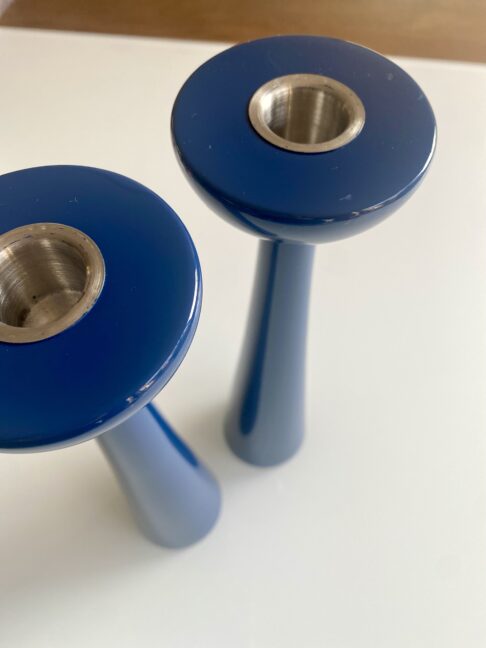 Tall blue coloured gloss candlesticks with a lacquered finish.