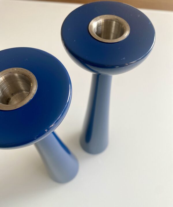 Tall blue coloured gloss candlesticks with a lacquered finish.