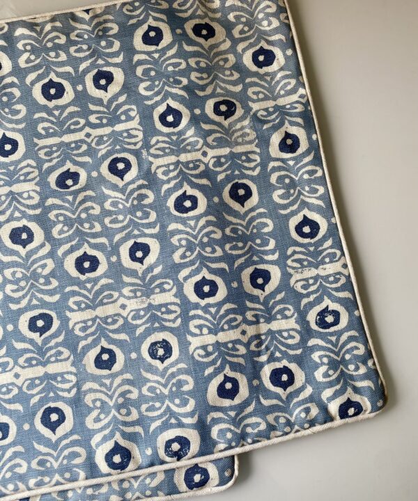 Pale blue Iznik hand-print cushion cover with plain linen piping.