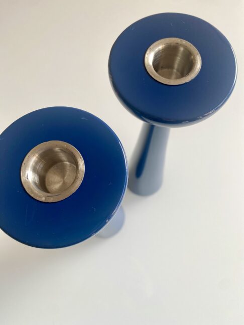 Overhead detail of glossy dark blue candlesticks.