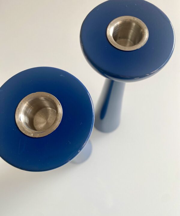 Overhead detail of glossy dark blue candlesticks.