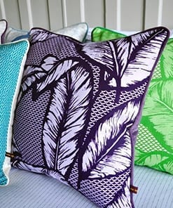 A deep purple, tropical leaf print cushion inspired by botanical gardens in Ghana. From the Eva Sonaike design studio.