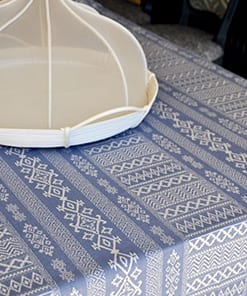 A blue and white, jacquard-woven tablecloth with an Arabian-motif-inspired design.