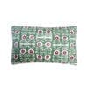 A rectangular, hand-printed linen green patterned cushion inspired by Middle Eastern motifs in red and green.