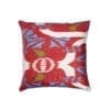 A red silk cushion in an Ikat design with blue and green accents measuring 50 x 50cm.