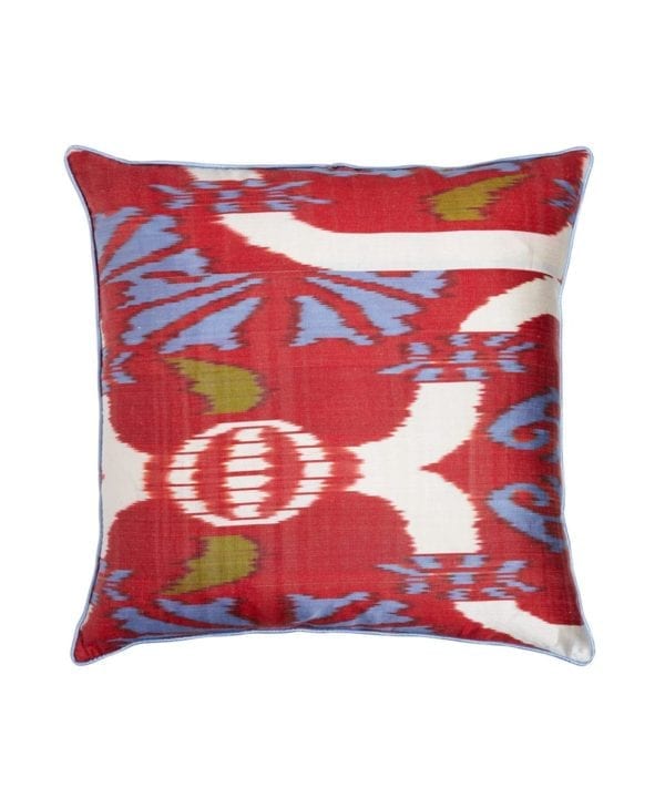 A red silk cushion in an Ikat design with blue and green accents measuring 50 x 50cm.