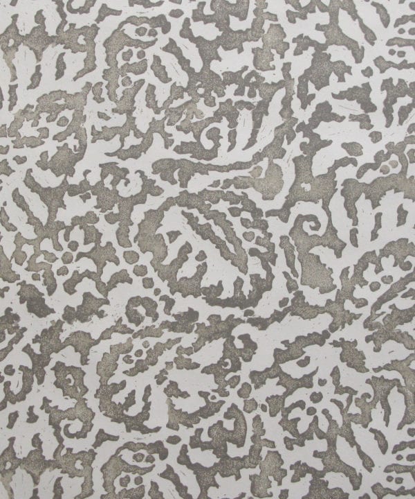 A close up of the Majolica, Italian inspired grey patterned wallpaper in a warm grey with a pale off-white ground.