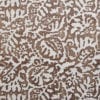 A close up of the Majolica, Italian inspired brown patterned wallpaper in earthy-hued Gaucho with a pale, off-white ground.