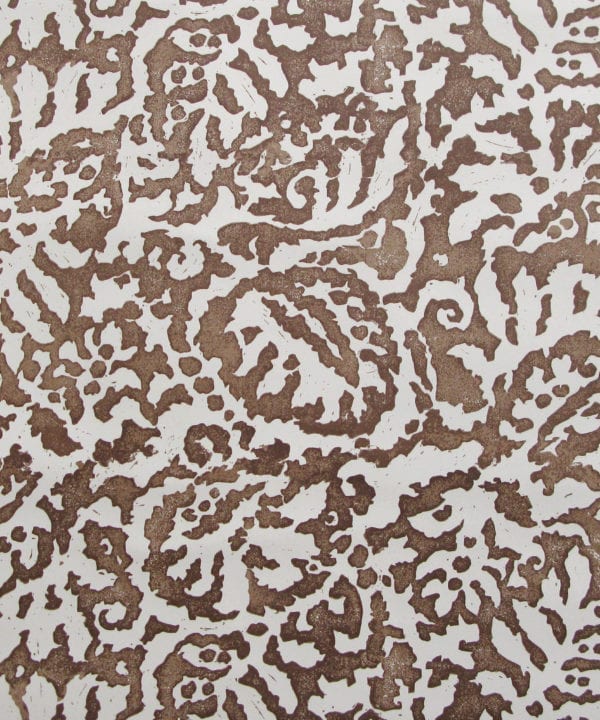 A close up of the Majolica, Italian inspired brown patterned wallpaper in earthy-hued Gaucho with a pale, off-white ground.