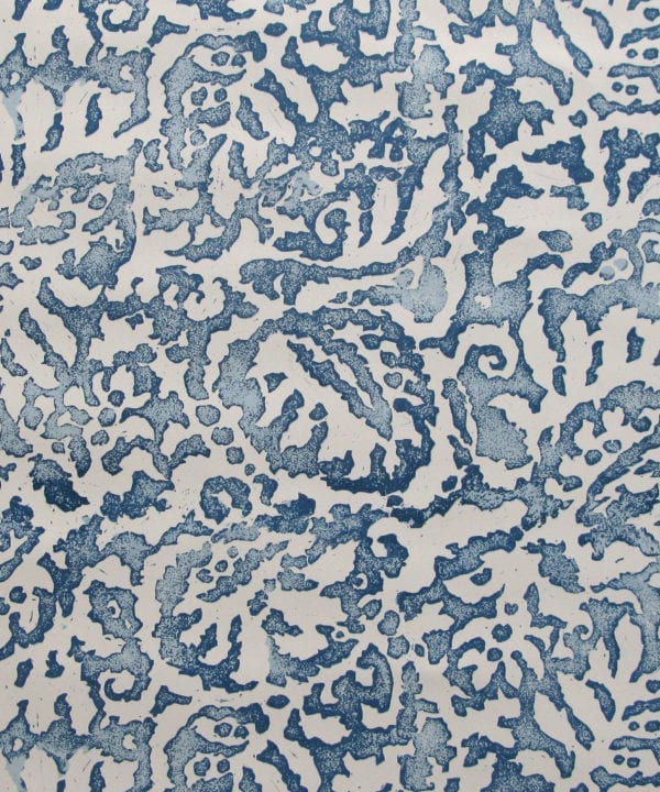 A close up of the Majolica, Italian-inspired, blue patterned wallpaper in Indigo with a pale, off-white ground.