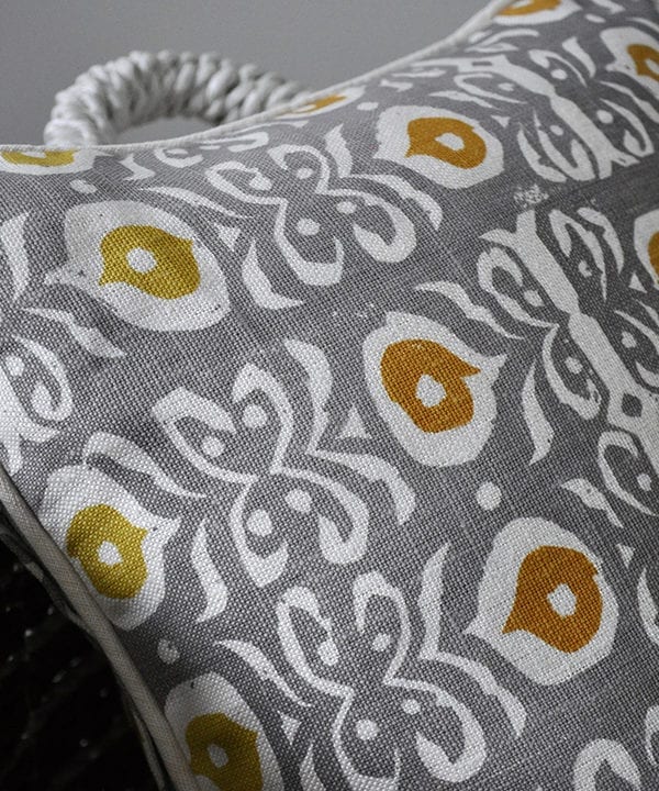 Detail of a grey and gold hand-print linen cushion with an Iznik design.