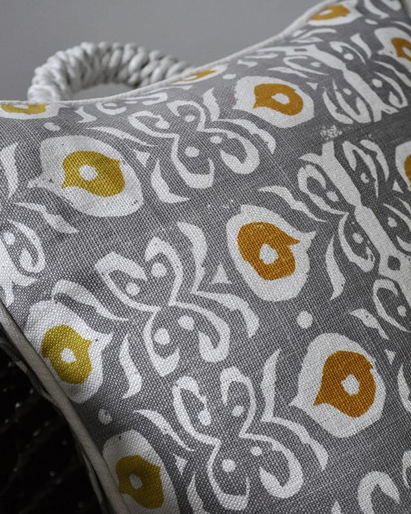 Detail of a grey and gold hand-print linen cushion with an Iznik design.