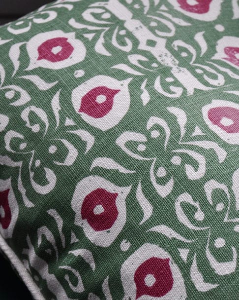 Detail of a green and red hand-print linen cushion with an Iznik design.