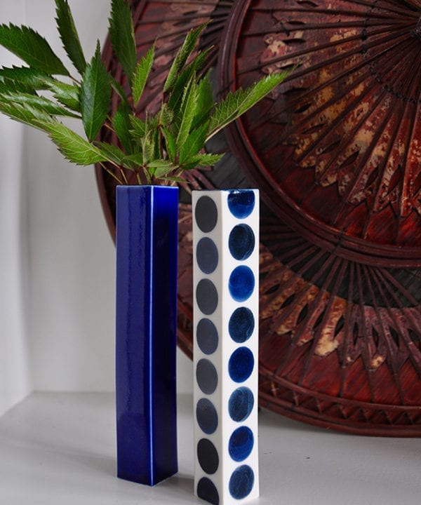 Japanese blue vases in polka dot and plain against a vintage Asian conical hat.