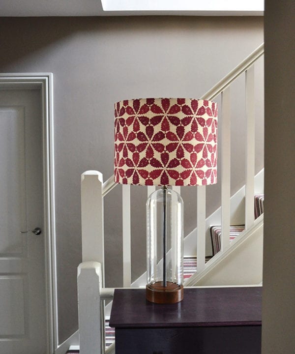 Cranberry red lampshade in 'Maroc' on a landing side table,Telescope Style.