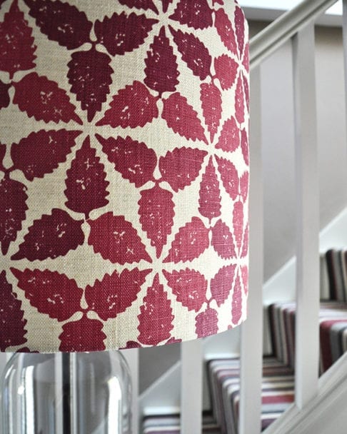 Close-up shot of a red, hand-printed linen lampshade in 'Maroc'.