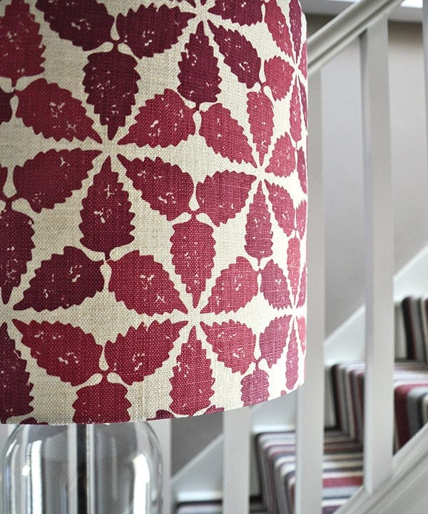 Close-up shot of a red, hand-printed linen lampshade in 'Maroc'.