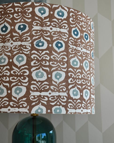 Detail of a teal blue and brown patterned lampshade.