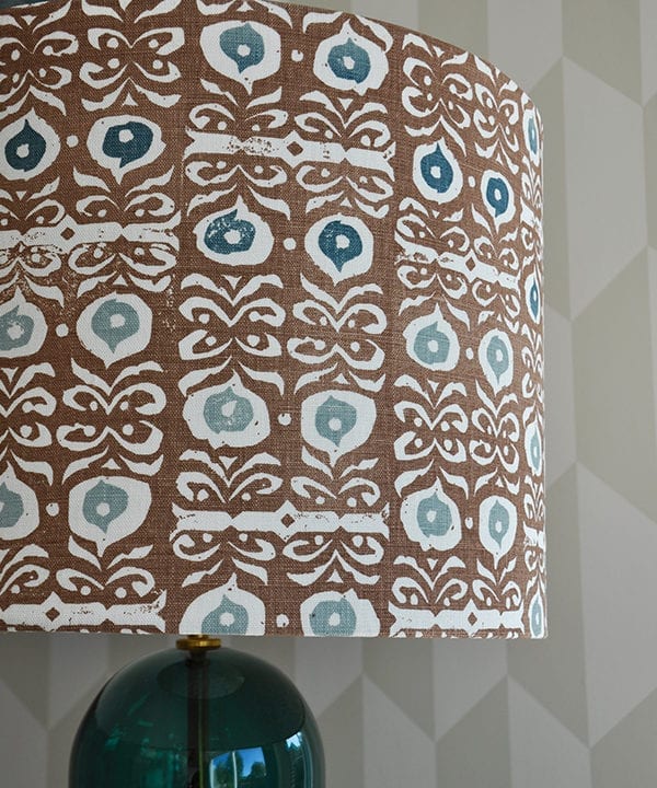 Detail of a teal blue and brown patterned lampshade.