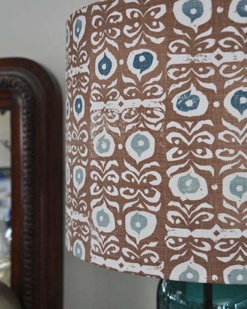 Close up shot of a patterned lampshade in cinnamon brown and teal blue.