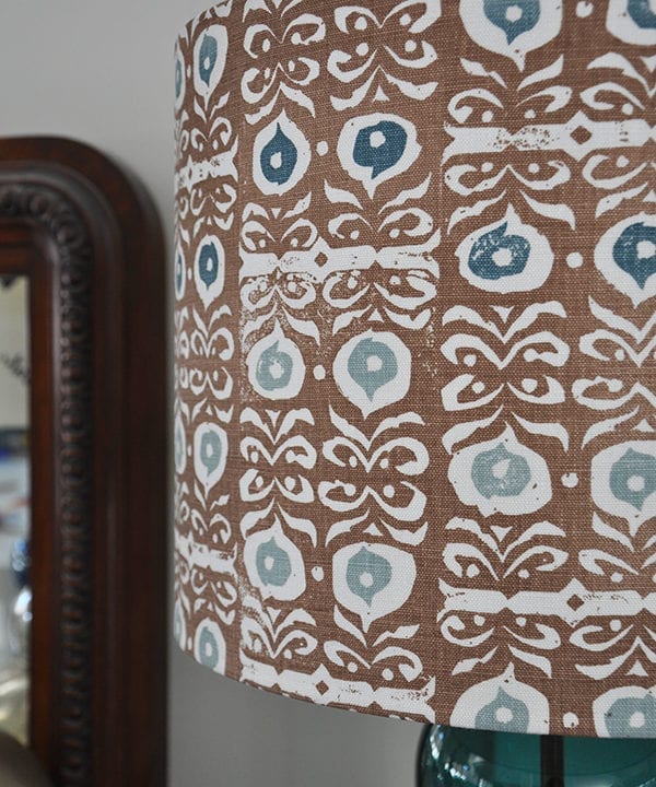 Close up shot of a patterned lampshade in cinnamon brown and teal blue.