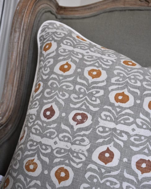 Detail of a celadon-colored, hand-print linen cushion on a French chair.