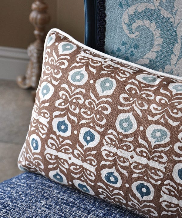 A brown hand-print linen cushion in an Iznik design.