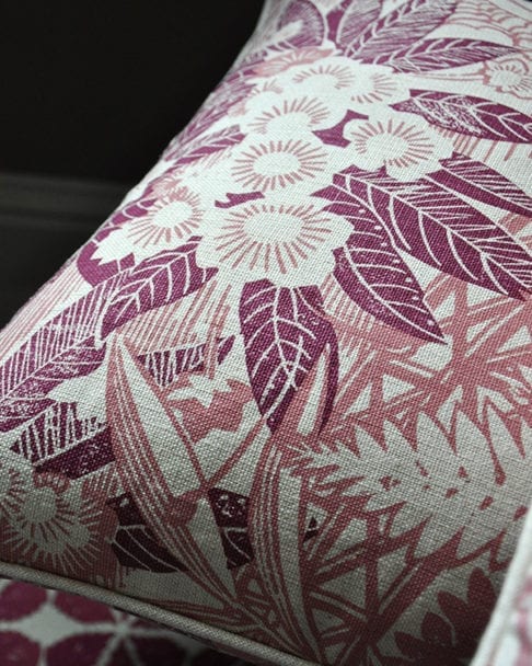 A close-up shot of Webb's Wonder printed linen pink floral cushion in the raspberry colourway from Telescope Style.