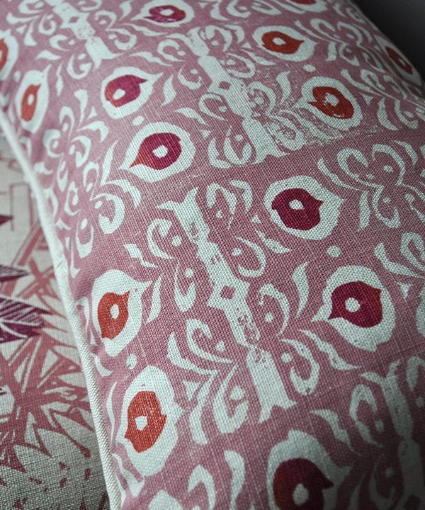 A pink, hand-print linen cushion in an Iznik design.