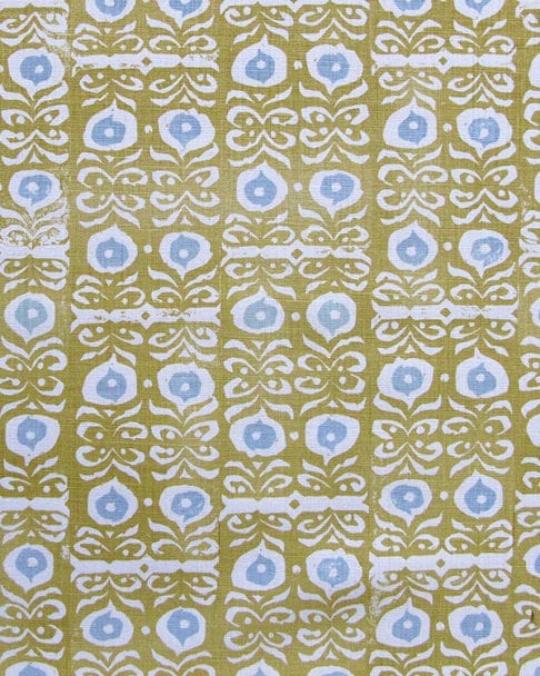 A close-up fabric shot of Iznik yellow patterned cushions in the Old Gold colourway available from Telescope Style.